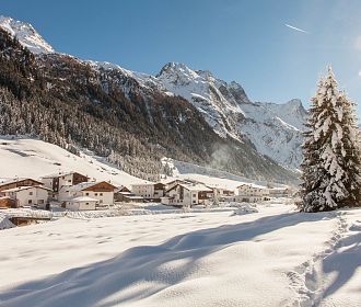 Blick auf das Dorf Piösmes im Winter der Gemeinde St. Leonhard
