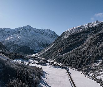 Das Bergdorf Tieflehn im Winter in der Gemeinde St. Leonhard mit dem Berggipfel Mittagskogel im Hintergrund